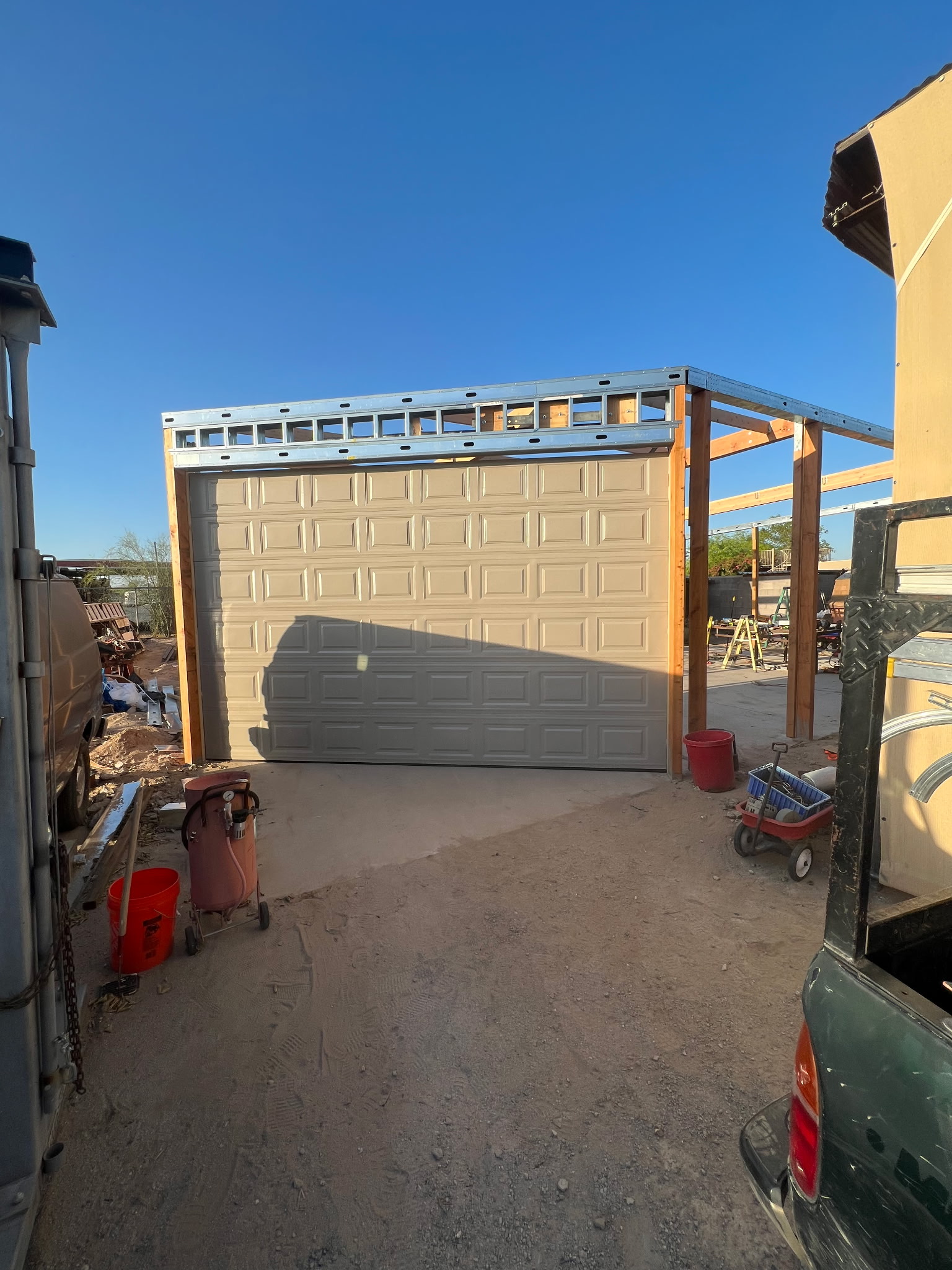 Tall commercial style garage door install in progress