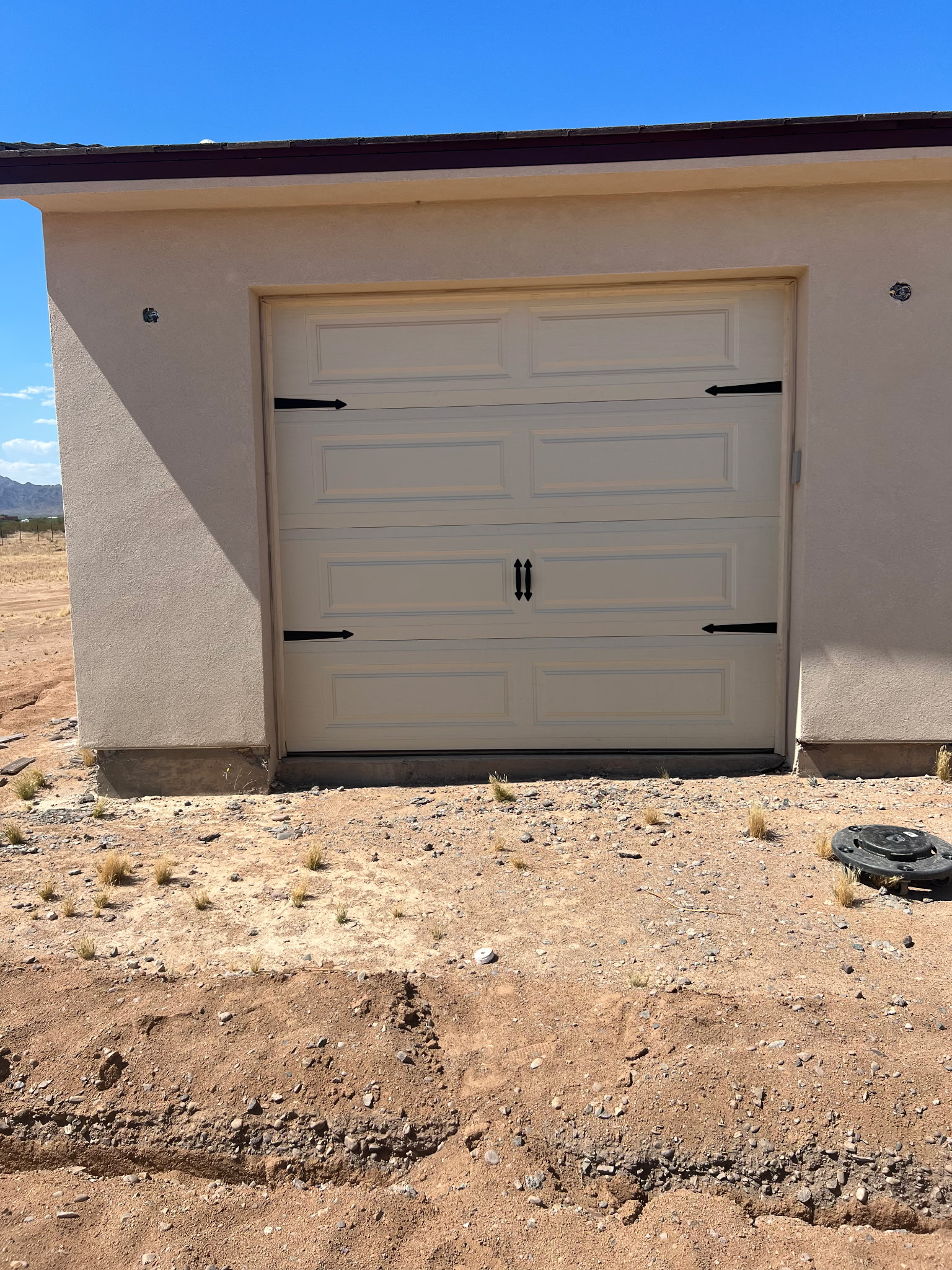 Carriage style garage door with decorative hardware in Arizona